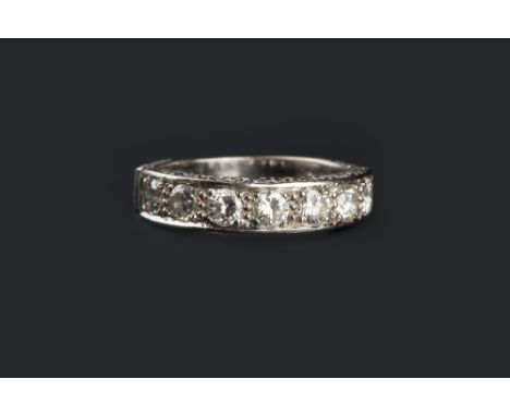 A DIAMOND HALF HOOP RING, the scroll engraved mount inset with a line of seven round brilliant-cut diamonds, 18ct white gold 