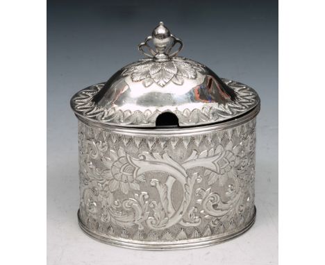 A VICTORIAN SCOTTISH SILVER MUSTARD POT, oval shaped with chased and engraved foliate decoration, matching domed lid and blue