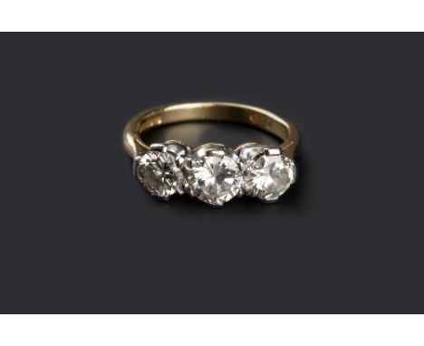 A DIAMOND THREE STONE RING, the graduated round brilliant-cut diamonds in claw setting, 18ct two colour gold mounted, total d