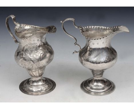 A GEORGE III SILVER HELMET JUG with a wavy edge, turned stepped foot and double 'C' scroll handle, 11.5cm high, London 1779 b
