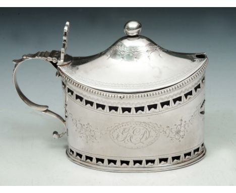 A GEORGE III SILVER MUSTARD POT, oval shaped with pierced and engraved decoration, matching domed lid and blue glass liner, 1