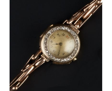 A LADY'S DIAMOND SET WRISTWATCH, the circular dial with Arabic numerals and outer minute scale, framed by a rose-cut diamond 