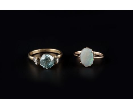 A BLUE ZIRCON AND DIAMOND DRESS RING, with scrolled shoulders, stamped '18ct',  and a cabochon opal single stone ring, first 