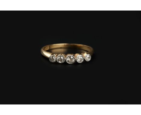 A DIAMOND FIVE STONE RING, the graduated old-cut diamonds in millegrained collet settings, above a scroll pierced gallery, to