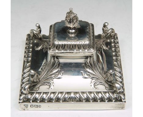 A VICTORIAN SILVER DESK STAND to incorporate a single inkwell in a square tapering base decorated with scrolled corners in re