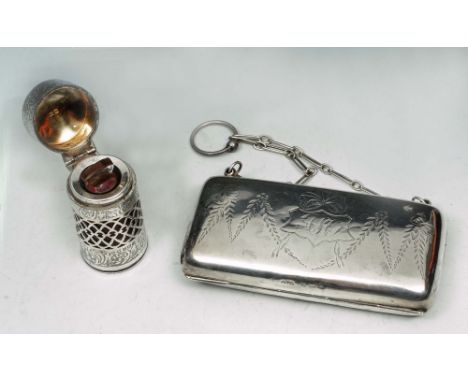 A GEORGE V SILVER RED GLASS LINED SCENT BOTTLE with pierced and engraved foliate decoration and stopper, 6cm high by G.E. Wal
