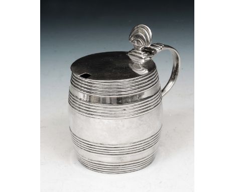 A GEORGE III SILVER MUSTARD POT in the form of a coopered barrel with a hinged lid and blue glass liner, 8.2cm high, London 1
