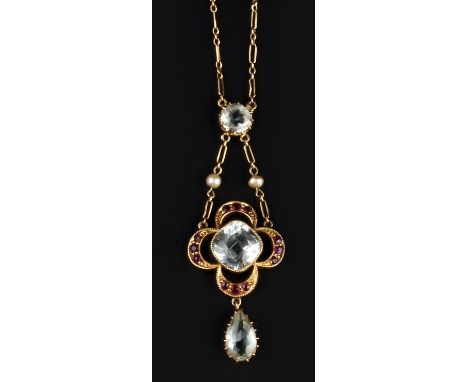 AN EARLY 20TH CENTURY AQUAMARINE AND RUBY PENDANT NECKLACE, the central cushion-shaped aquamarine framed by an openwork quatr