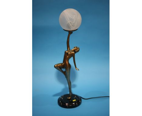 An Art Deco style figural table lamp, the lady holding aloft the shade.