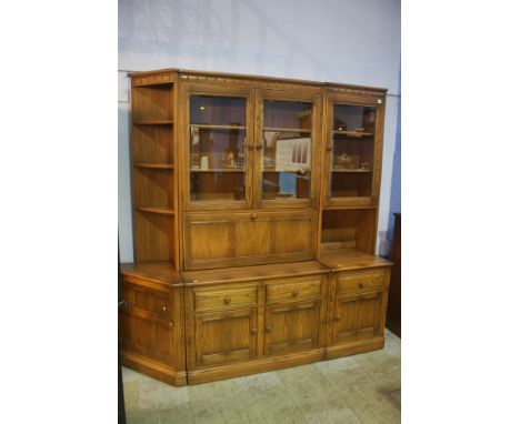 A three section Ercol display cabinet.