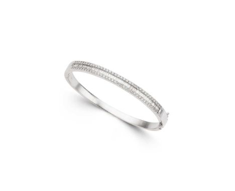 A diamond bangle of hinged design, the front channel-set with a row of baguette-cut diamonds in a border of round brilliant-c