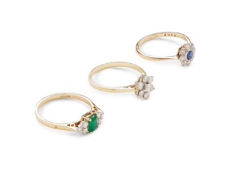 Three gem-set rings including a diamond cluster ring, modelled in 18ct gold; an emerald and diamond ring, modelled in 18ct go