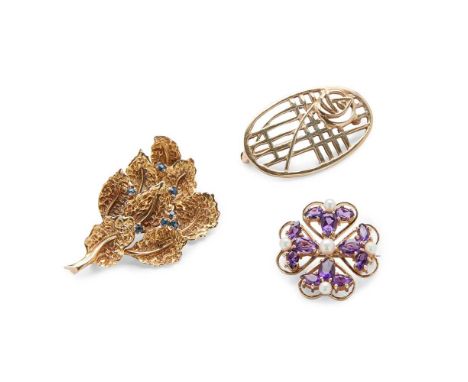 A collection of three brooches including a 9ct gold sapphire foliate brooch, by Deakin &amp; Francis; a 9ct gold pierced Mack