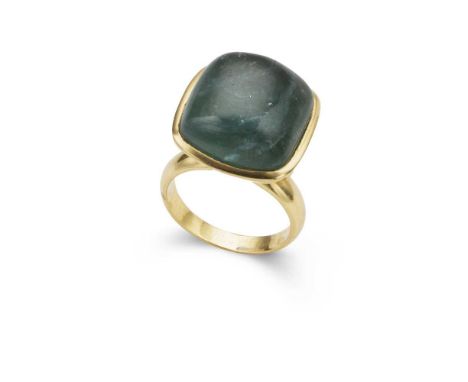 A tourmaline ring the cabochon bluish green tourmaline in a raised collet setting, beaded details on each side, to a plain ba