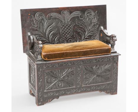 LATE VICTORIAN CARVED OAK MONKS BENCH 
with folding top and hinged seat, with lion carved arm rests,107cm wide