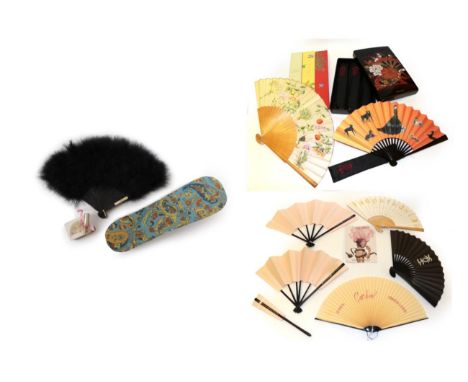 A Perfumed Fan, black feathers mounted on black plastic, the upper guard with a gold embossed label "GEMINESSE Fragrance fan 