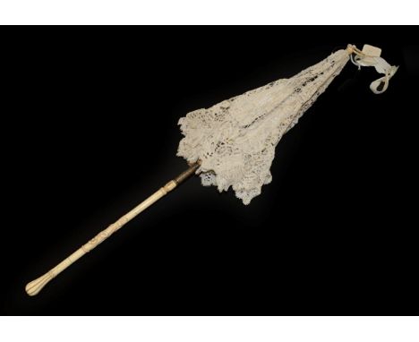 A 19th Century Folding Parasol, the cover of light cream tapelace, perhaps Milanese, the lining a lightweight cream silk repl