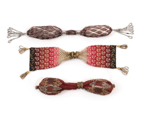 Three 19th Century Miser's or Stocking Purses, using three different styles. The first, handstitched from a dense fabric, is 