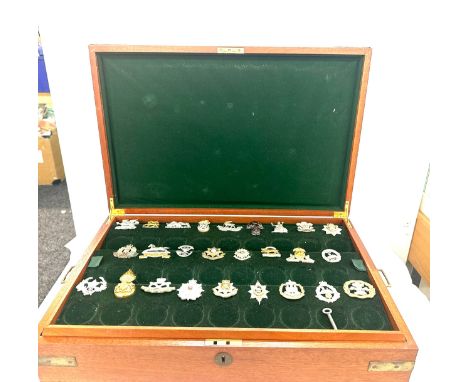 Wooden brass bound box with assorted Army badges 