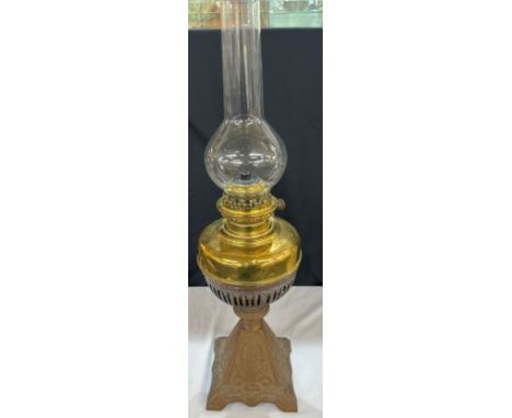 Vintage cast iron base oil lamp measures approximately 27 inches tall