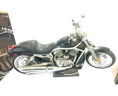 Harley davidson motorbike model on stand, measures approximately 26 inches long