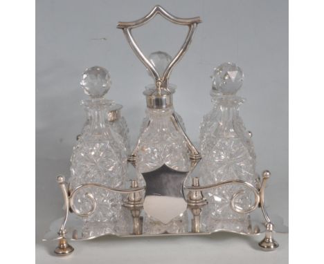 An antique silver plated and cut glass six piece condiment cruet set manufactured by Pleasance and Harper comprising of salt 