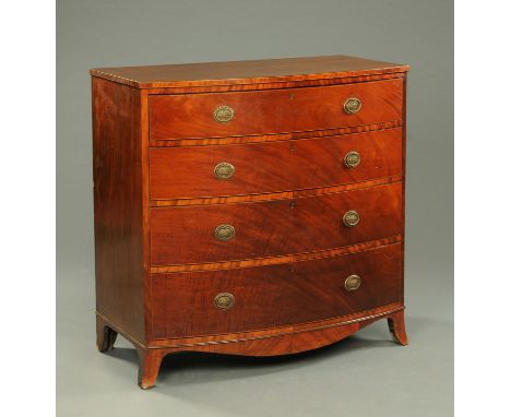 A 19th century mahogany bowfronted chest of four drawers, with brass drop handles with oval backplate, being boxwood and ebon