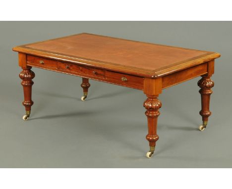 A large Victorian mahogany library table, rectangular, with tooled leather writing surface and rounded corners, the frieze wi
