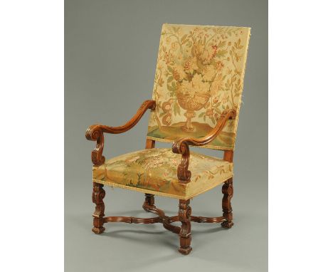 A late 19th century walnut tapestry armchair, with urn and foliate back and stuffover seat and with exposed moulded showframe
