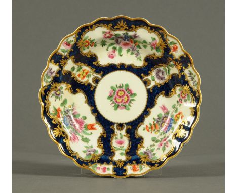 A Worcester Scale Blue porcelain lobed dish, decorated with flowers.  Diameter 19 cm.    CONDITION REPORT:  This plate has be