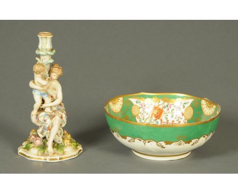 A 19th century green and gilt fruit bowl, and a Sitzendorf style figural candlestick.  Bowl diameter 26 cm. 