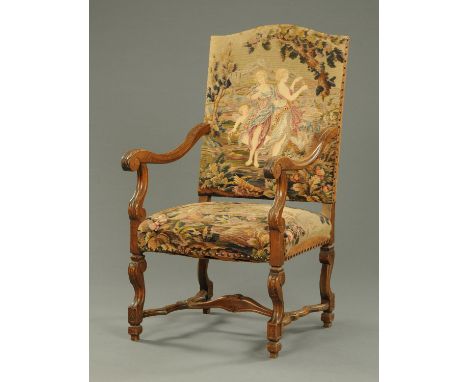 A large Continental walnut armchair, early 20th century, with tapestry back and seat and raised on carved front legs with sha