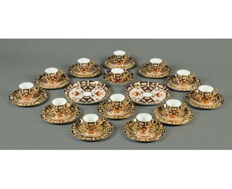 A Royal Crown Derby tea service, comprising 2 large serving plates, 12 plates, 12 saucers, 12 cups and bowl (see illustration