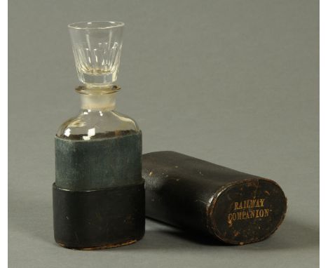 A 19th century "Railway Companion", the flask stopper as a shot glass and housed in a leather bound cylindrical case.  Height