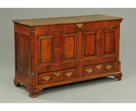 A George III oak mule chest, with moulded edge above four panels, with two drawers beneath and raised on bracket feet.  Width