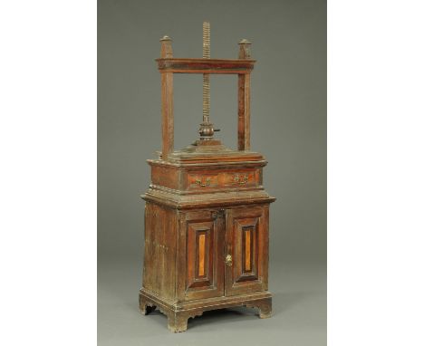 A 19th century oak and walnut linen press, the superstructure with drawer, the base with a pair of panelled cupboard doors wi