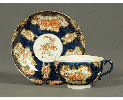 A Worcester Scale Blue porcelain tea cup and saucer, decorated in the Japanese Kakiemon style.     CONDITION REPORT:  The sau