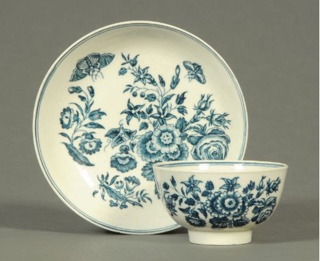 A Worcester tea bowl and saucer, foliate and butterfly, crescent mark to base.