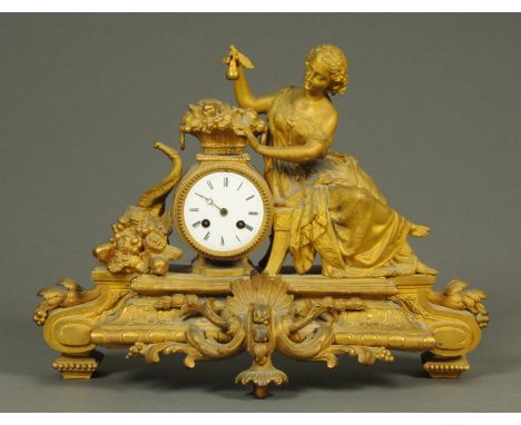 A French figural mantle clock, with lady and basket of flowers and with two-train striking movement.  Height 38 cm, length 51