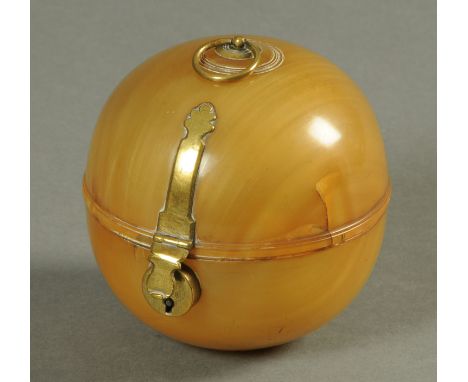 A George I brass mounted horn tea caddy, of globular form.  Diameter 11.5 cm.  Sold with copy receipt dated 1995 from Alistai