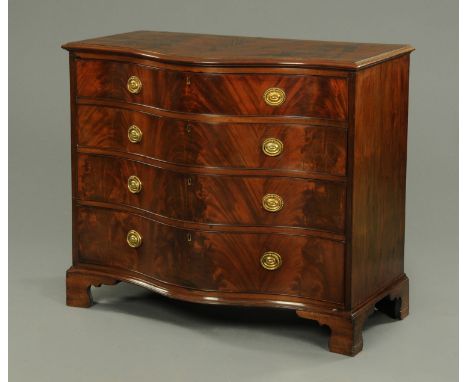 A 19th century mahogany serpentine fronted chest of drawers, with crossbanded edge above four long graduated drawers with bra