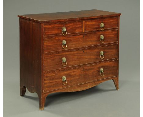 A George III mahogany chest of drawers, with two short and three long graduated drawers with brass drop handles with lion mas