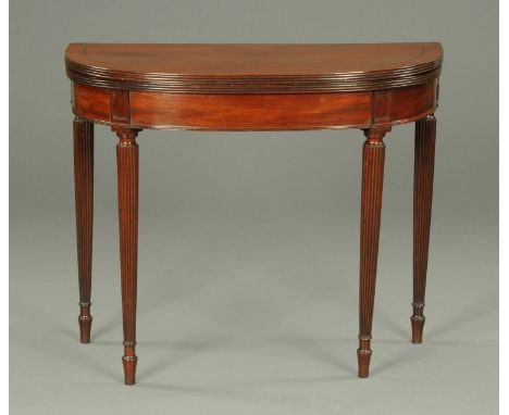 A Regency mahogany turnover top card table, ebony strung and raised on turned tapered reeded legs.  Width 92 cm. 