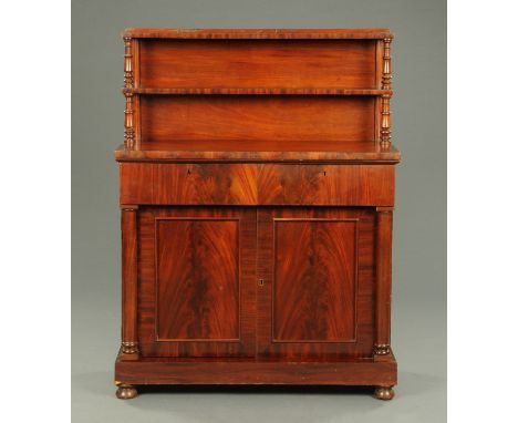 An early Victorian mahogany chiffonier, with shelved superstructure and two drawers and pair of panelled cupboard doors to th