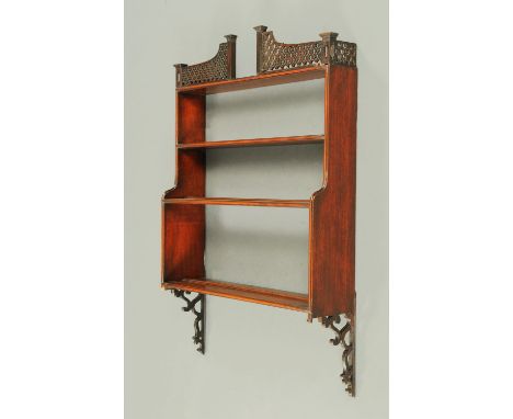 A 19th century mahogany hanging shelf unit, with fretwork pediment and bracket supports.  Width 61 cm.  