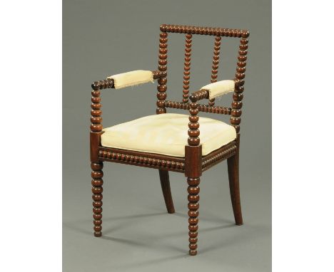A Regency bobbin turned and woven cane armchair, with original horsehair pad, circa 1830.   