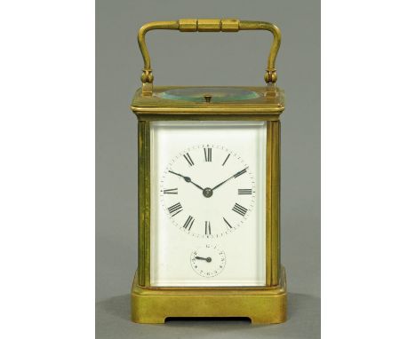 A French brass carriage clock, two-train striking with a gong and with alarm and repeat mechanism.  Height excluding carrying