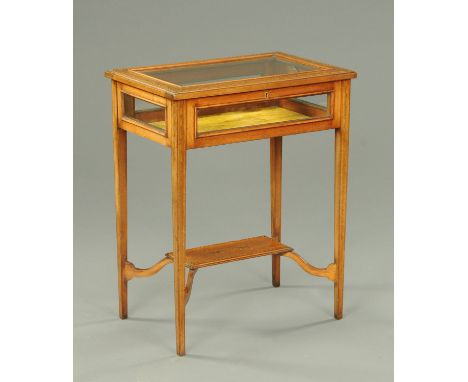 An Edwardian inlaid mahogany rectangular bijouterie table, with hinged top and raised on tapered legs of square section unite