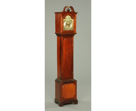 A mahogany grandmother clock, with swans neck pediment above the arched glazed door enclosing the silvered brass dial with th