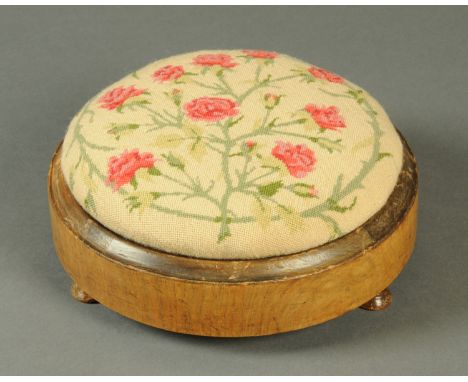 A late Victorian walnut circular footstool.   CONDITION REPORT:  The needlework is not original. The needlework is also not o